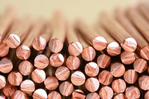 Cross section of many slim copper pipes piled on top of each other