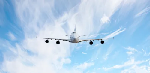 White passenger airplane flying in the sky amazing clouds in the background - Travel by air transport