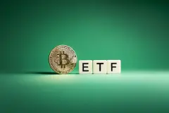 Golden Bitcoin facing camera next to three scrabble tiles spelling out ETF