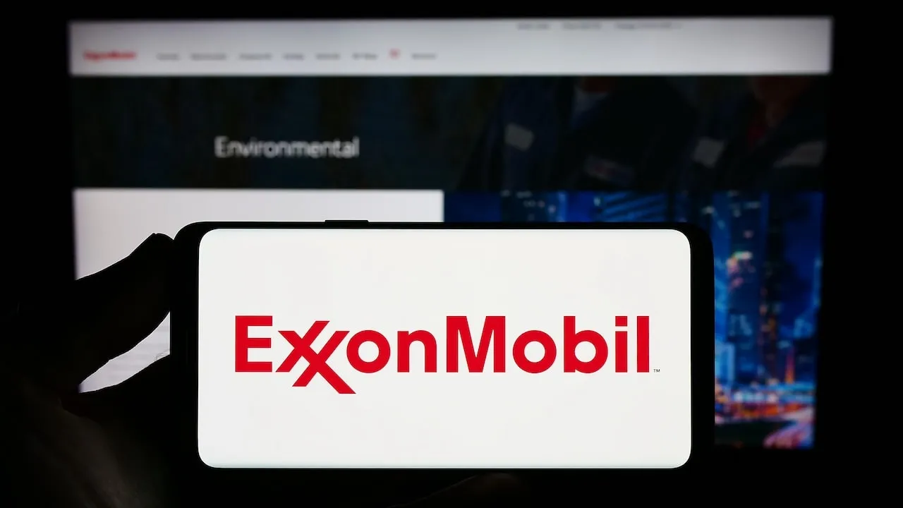 ExxonMobil (XOM Stock) Logo in red on white smartphone screen