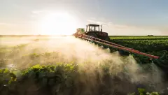 Tractor spraying fertiliser on crop Fertilizer Stocks Surge Amid Global Tensions