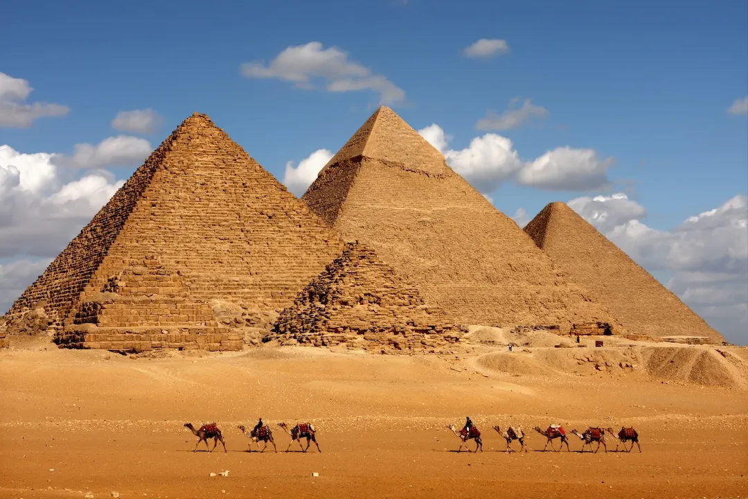 pyramids giza cairo in egypt with camel caravane panoramic scenic view