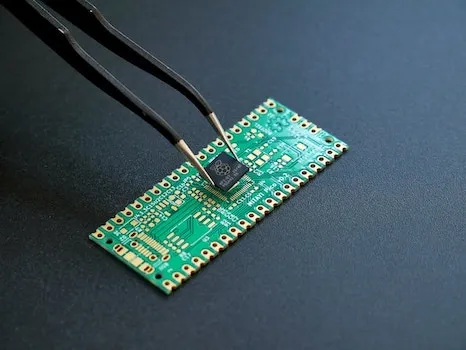 Semiconductor Chip adjusted and built with tweezer tool on black background