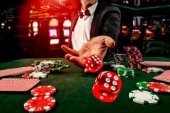 Gambling concept. Close up of male hand throwing dice at casino, gambling club. Сasino chips or Casino tokens, poker cards, gambling man spending time.