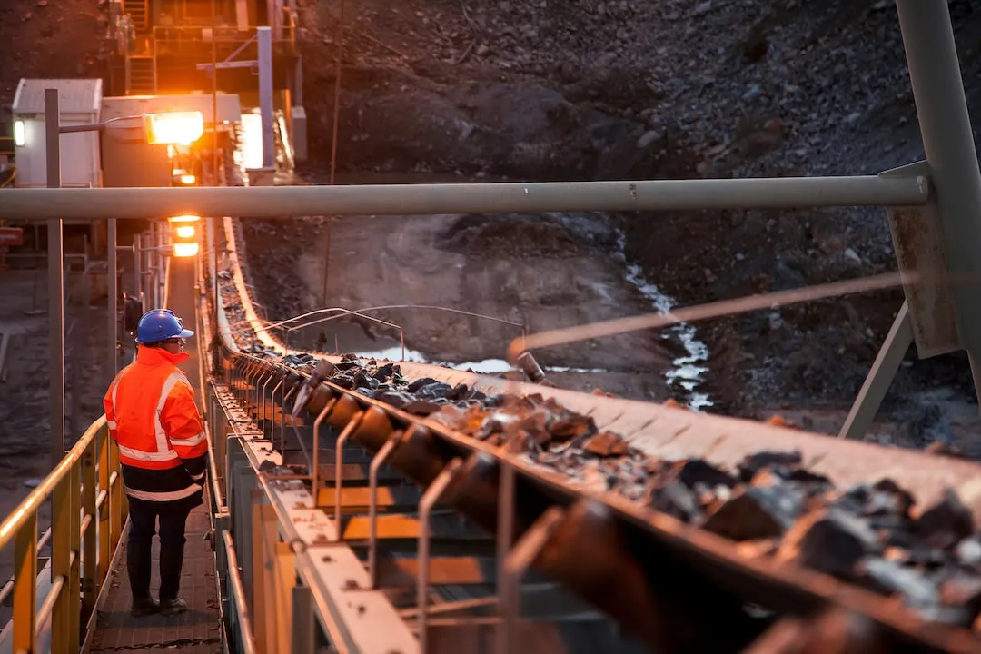 Miners watching a Conveyer at a Mine 
