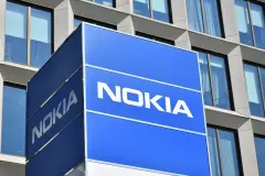 Nokia logo on blue box sign protruding from building.