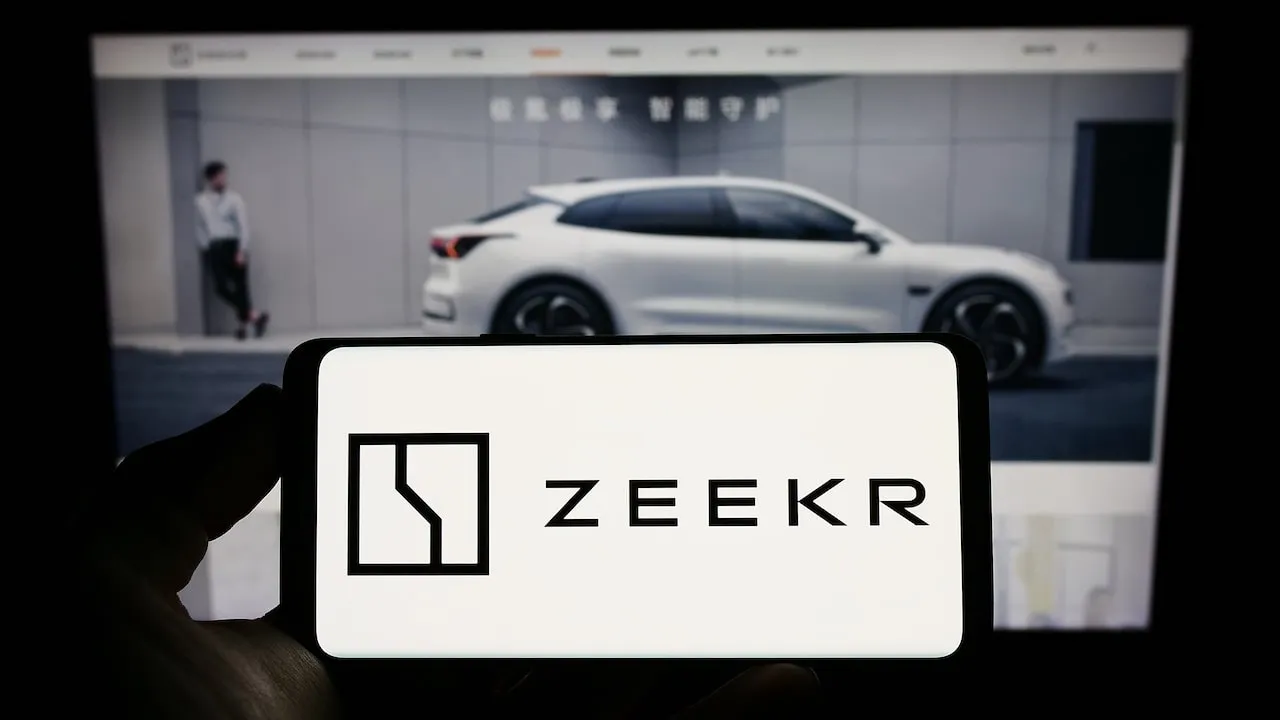 ZEEKR Logo on Smartphone in front of Zeekr EV on Webpage Screen