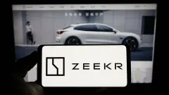 ZEEKR Logo on Smartphone in front of Zeekr EV on Webpage Screen