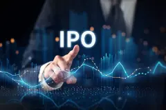 Finger pointing to glowing stock chart, letters IPO above.