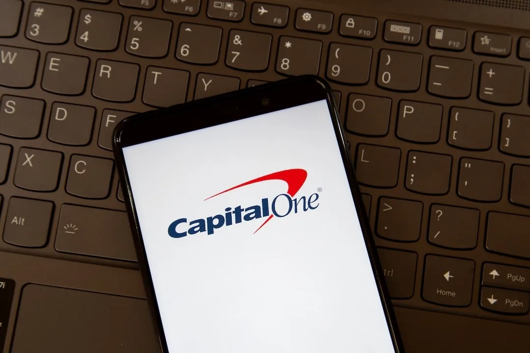 Capital One logo on smartphone screen on a keyboard. Capital One Financial Corporation is an American bank holding company. Capital One, Capital One Finance