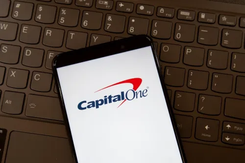 Capital One logo on smartphone screen on a keyboard. Capital One Financial Corporation is an American bank holding company. Capital One, Capital One Finance