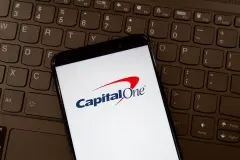 Capital One logo on smartphone screen on a keyboard. Capital One Financial Corporation is an American bank holding company. Capital One, Capital One Finance