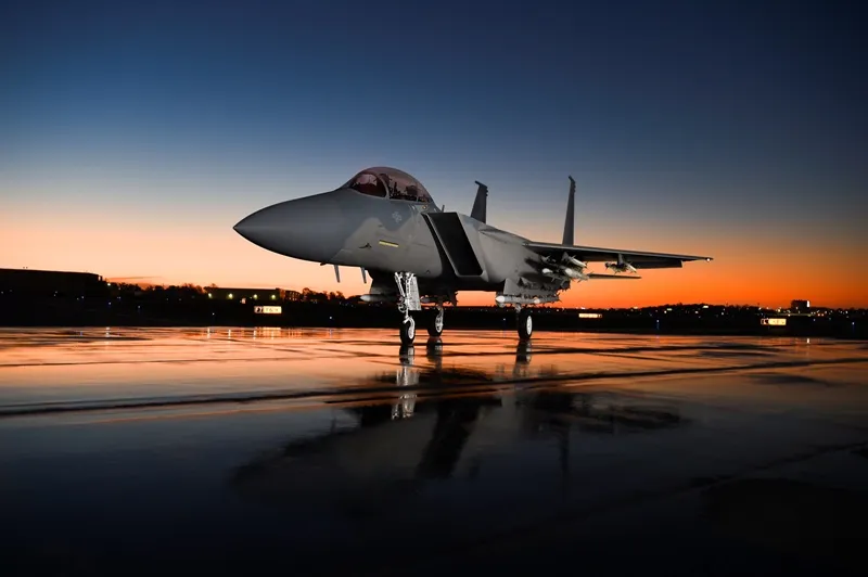 Boeing fighter jet on tarmac in low light