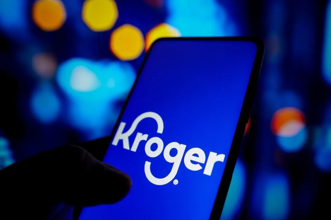 In this photo illustration, the Kroger Company logo seen displayed on a smartphone screen.