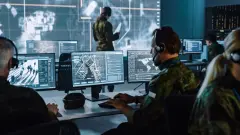 Military Surveillance Officer Working on a City Tracking Operation in a Central Office Hub for Cyber Control and Monitoring for Managing National Security, Technology and Army Communications.