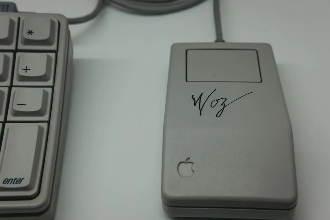 An early version of the Apple computer mouse with Woz signature on it and Apple icon.