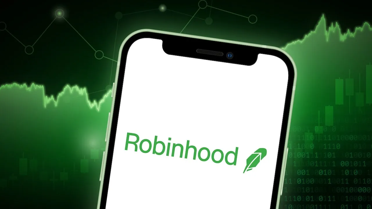 Robinhood Markets Logo on smartphone screen with green trading charts in background.