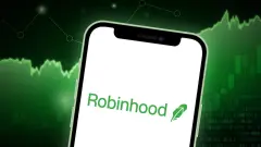 Robinhood Markets Logo on smartphone screen with green trading charts in background.