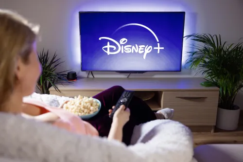 Woman watching Disney Plus on Large TV