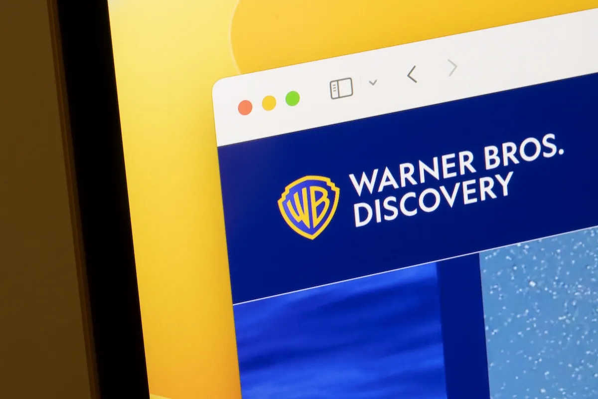Closeup of the Warner Bros. Discovery logo seen on its website. Warner Bros. Discovery, Inc. is an American multinational mass media and entertainment conglomerate.