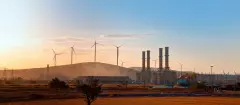 Silhouette of Natural gas processing plant with Renewable energy wind turbines generating electricity