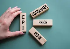 CPI - Consumer Price Index symbol. Concept word CPI on wooden blocks. Businessman hand. Beautiful grey green background. Business and CPI concept.