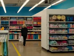 Woman shopping for craft materials in brightly lit store