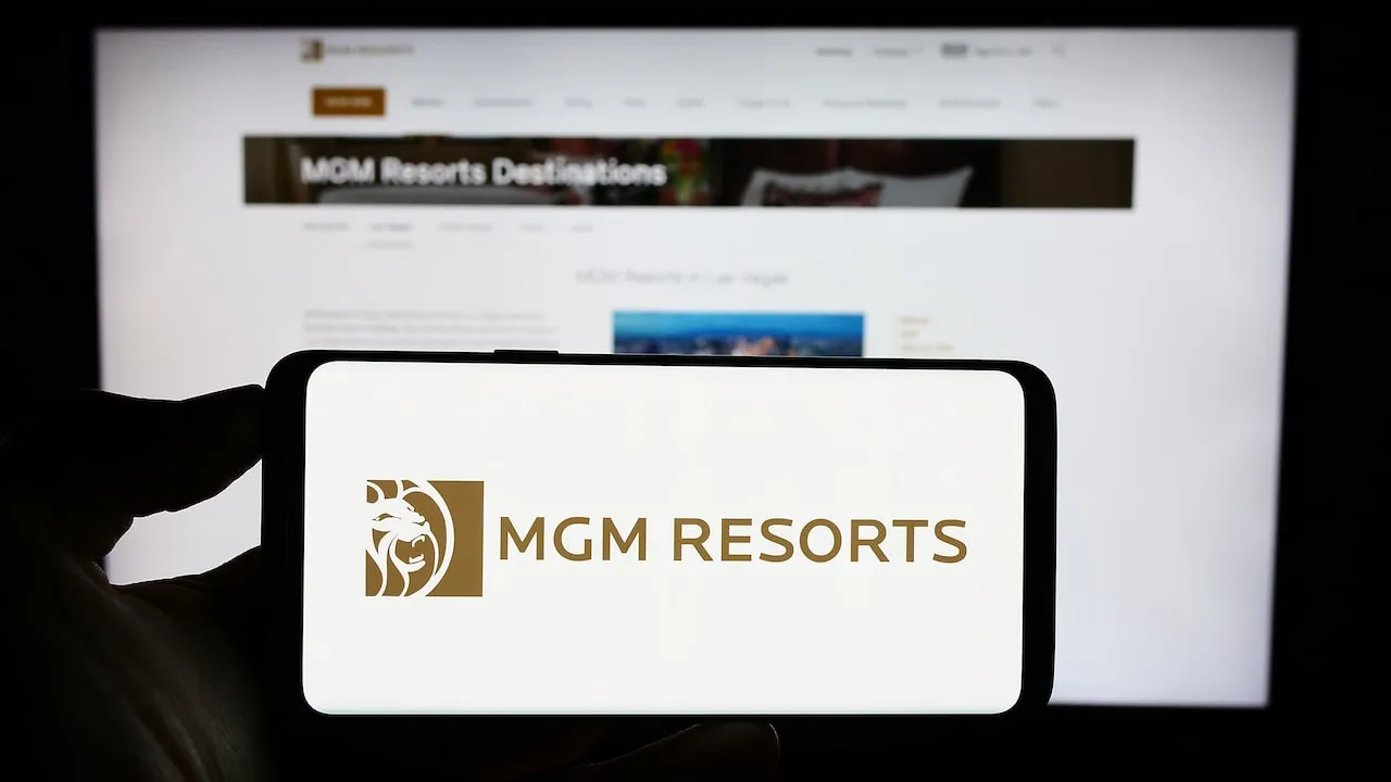 MGM Resorts International Logo on Smartphone against blurred website background.