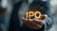 Golden IPO: The image captures a close-up of a person's hand holding a glistening "IPO" symbol with an abstract stock chart in the background, embodying a sense of financial growth.