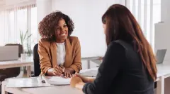 Woman consulting with a female financial manager at the bank