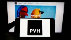 PVH Corp Logo on phone with Website on Screen in background