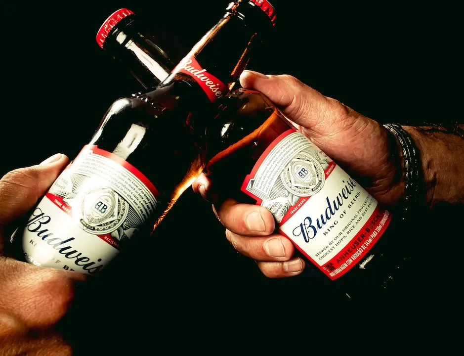 Hands clinking bud bottles