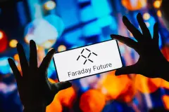 Faraday Future logo on smartphone held between two hands