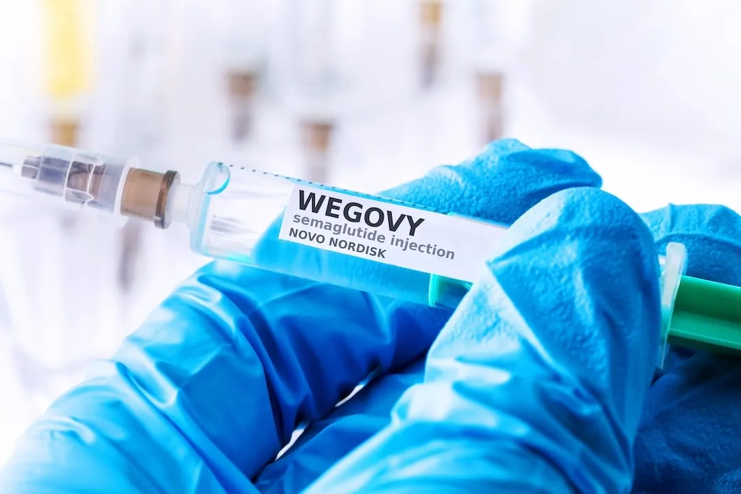 Wegovy labeled syringe held by blue gloved hand novo nordisk