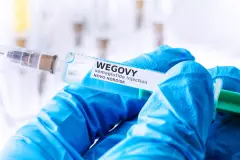 Wegovy labeled syringe held by blue gloved hand novo nordisk
