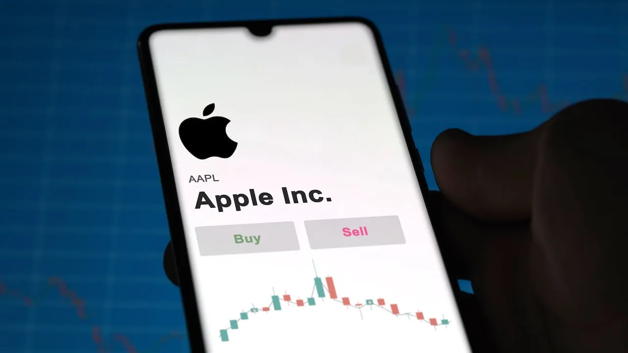 Apple Logo and Stock profile on Smartphone Handset.