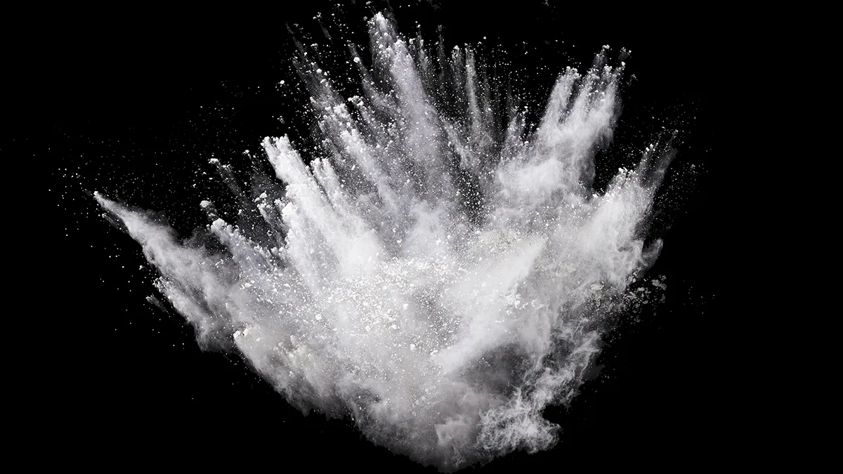 White powder explosion on black background.