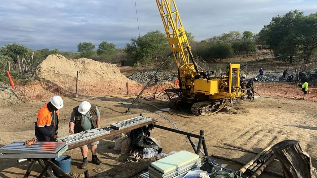 Mining Operation Kavango Resources Workers examining ore and busy on site.