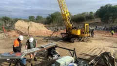 Mining Operation Kavango Resources Workers examining ore and busy on site.
