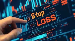 Close-up of a trader's hand interacting with a stop-loss feature on a digital trading platform, representing risk management in financial markets.