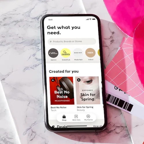 Klarna app on smartphone against white marble countertop