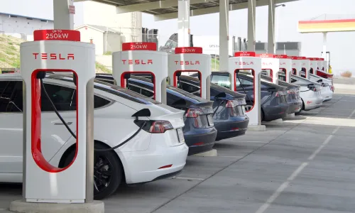 TSLA stock of cars parked at Tesla chargers