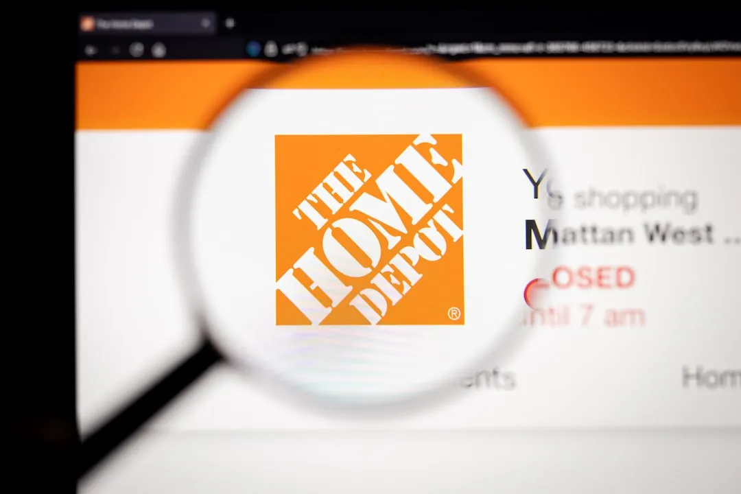 The Home Depot logo under a magnifying glass orange and white