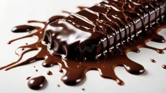 Delicious chocolate bar melting into a rich, smooth pool of gooey, creamy chocolate sauce.