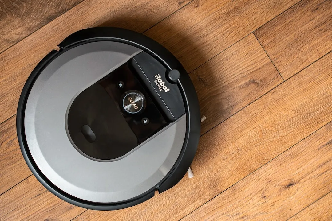 Photo iRobot Roomba i7 robot vacuum cleaner on a wooden floor, illustrative editorial. IRBT