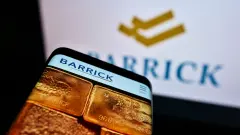 Barrick Logo on smartphone screen and behind GOLD stock