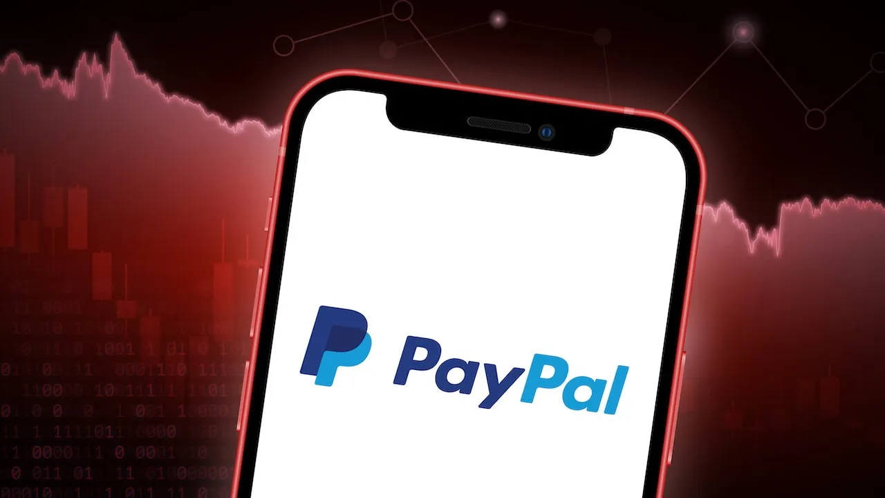 PayPal logo on Smartphone with red downward stock chart behind.