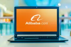 Alibaba.com appears on Laptop screen with orange background