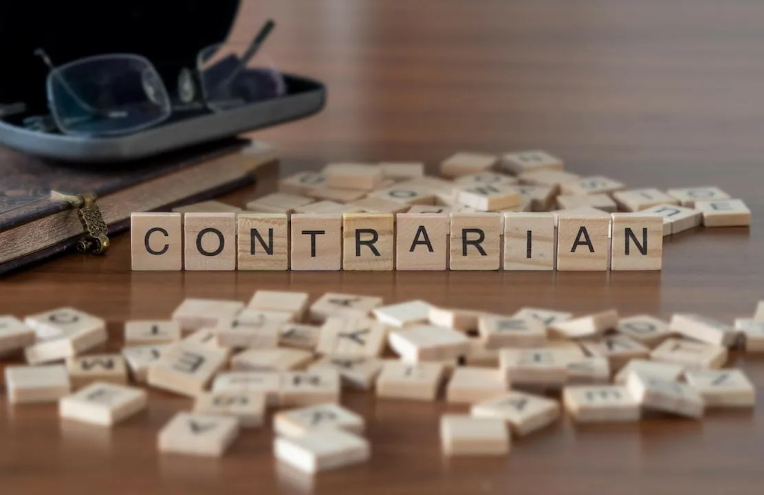 Scrabble tiles spelling the word CONTRARIAN