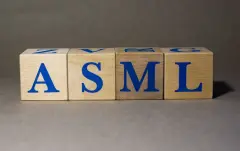 New York, USA. Exchange Ticker symbol of the company ASML Holding ASML, made of wooden cubes, on a gray background.